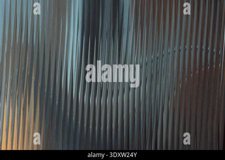 Abstract close up of swirling textures in shades of gray brown and blue creating a dynamic composition Stock Photo