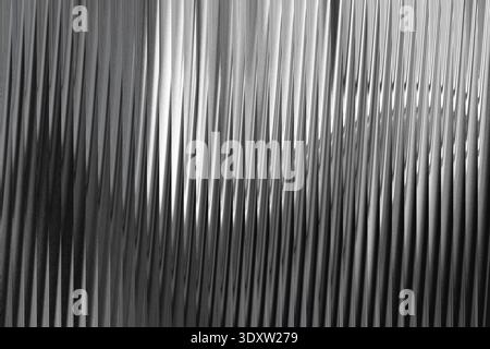 Abstract monochrome image featuring curved metallic structures with blurred motion and soft lighting Stock Photo