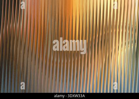 Abstract image featuring flowing golden and peach colored fabric with blurred background elements present Stock Photo