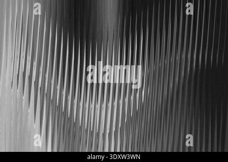 Abstract grayscale image featuring blurred vertical lines and gradient light and dark areas throughout scene Stock Photo