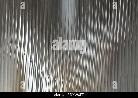 Abstract blurred motion of gray and white shades creating a vertical pattern with a central line feature Stock Photo