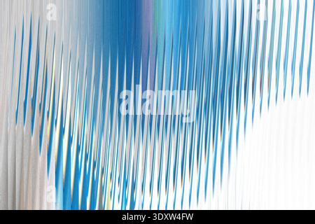 A blurred image featuring a vibrant mix of blue, green, and white colors in an abstract composition Stock Photo