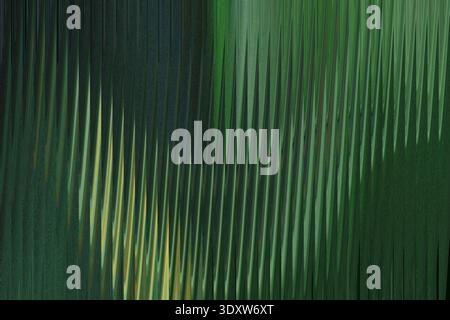 A blurry abstract image featuring shades of green and dark tones with some light streaks visible too Stock Photo