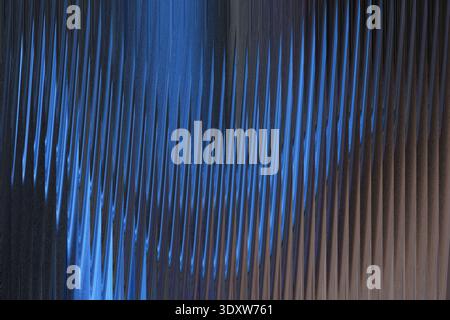 A blurry abstract image showing a gradient of blue merging into darker shades of brown and black tones Stock Photo