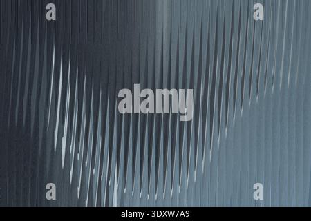 A blurry abstract image featuring a vertical white streak against a dark gray and blue background gradient Stock Photo