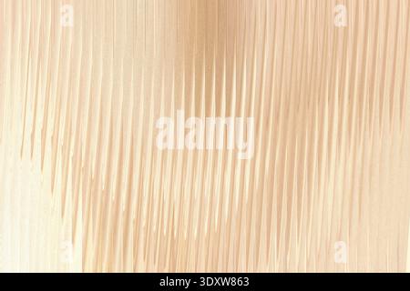 Close up of a light beige fabric showing subtle vertical lines and soft blurred edges in the background Stock Photo
