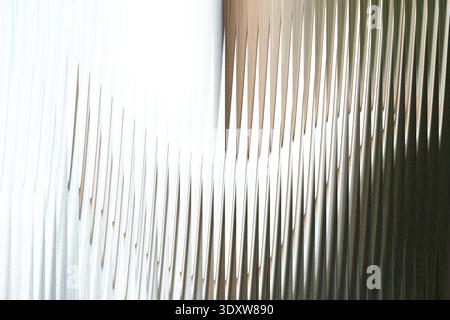 A blurry abstract image featuring shades of white with hints of brown and dark green in the background Stock Photo