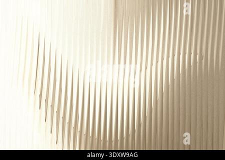 Abstract image showing a vertical crease dividing a beige and brown gradient background evenly split Stock Photo