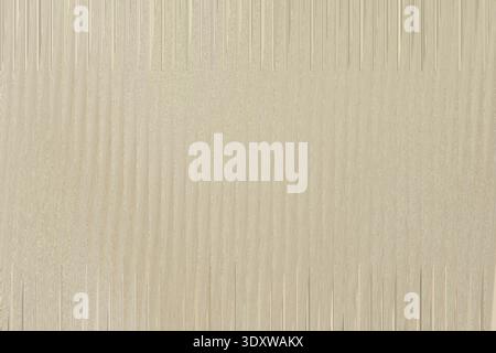 A subtle beige texture creates a versatile and neutral background with a fine, grainy pattern Stock Photo
