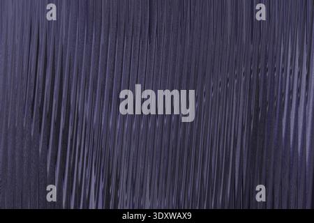 A dark blue textured background features a subtle gradient, creating an abstract and moody pattern Stock Photo