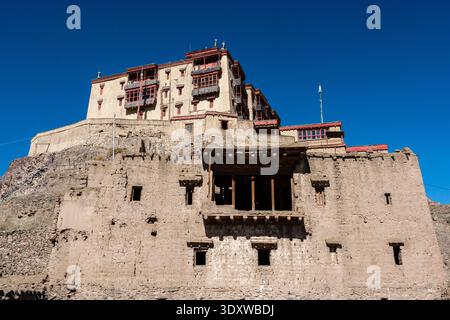 Low angle view showing the massive stone walls and decorative wooden balconies of the multi-storey Stok Palace under a clear sky. Stock Photo