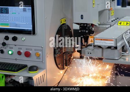 Close up of CNC fiber laser pipe cutting machine processing. Selective focus. Stock Photo