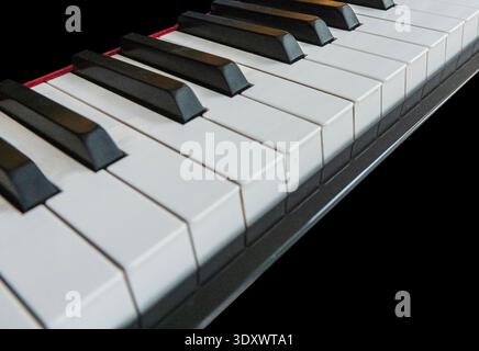 Close up of white and black piano keys in perspective Stock Photo