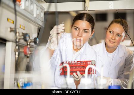 Confident women technicians working in research laboratory Stock Photo