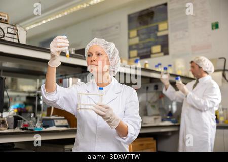 Focused female technician working in research laboratory Stock Photo