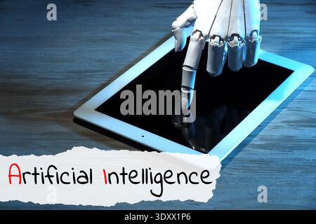 Robot using tablet computer. Text Artificial Intelligence on torn paper Stock Photo