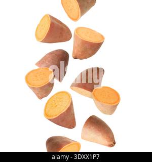 Sweet potato pieces falling against white background Stock Photo
