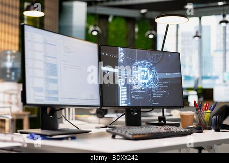 Empty tech industry startup workspace leveraging machine learning technology to automate scripts. Office with AI tools running on PC to review code files for potential bugs Stock Photo