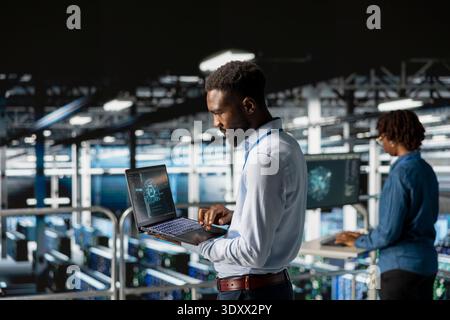 Technicians team on data center industrial platform analyzing neural network after troubleshooting software updates. Server hub engineers finetuning infrastructure configurations. Stock Photo
