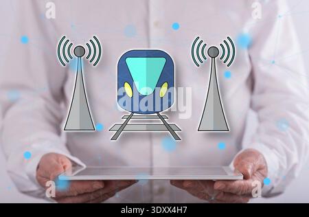 Smart train concept above a tablet held by a man in background Stock Photo