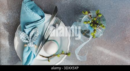 Easter Table Setting with Blue Napkin and Egg.. Stock Photo