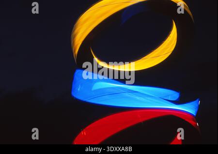 Three colored lights in motion forming a pattern. Yellow blue red Stock Photo