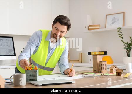 Male construction engineer drawing zoning plan in office Stock Photo