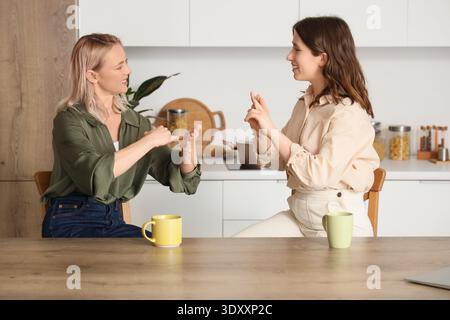 Women using sign language at home Stock Photo