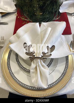 Sabu -Christmas Table Setting with Black & White Plates and Deer Antler Napkin Ring Stock Photo