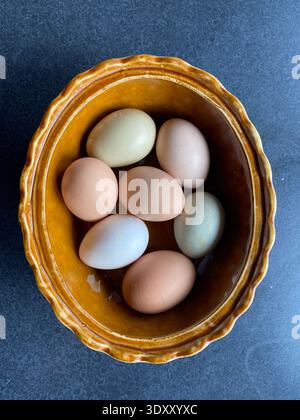 Multi Colored Farm Fresh Eggs in Ceramic Bowl Stock Photo