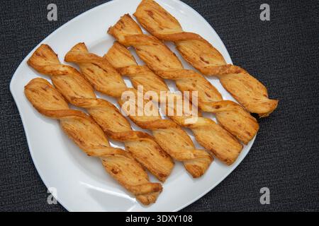 savory cheese twists, also commonly known as cheese straws or puff pastry twists. Stock Photo