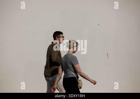 BANGKOK, THAILAND-Feb 15, 2026: Tourist couple walking, tourists exploring city streets on foot, side profile Stock Photo