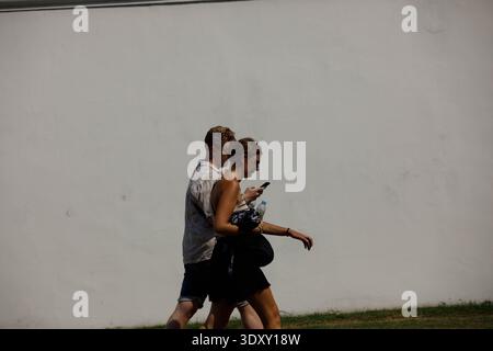 BANGKOK, THAILAND-Feb 15, 2026: Tourist couple walking, travel exploration through city walking, side profile Stock Photo