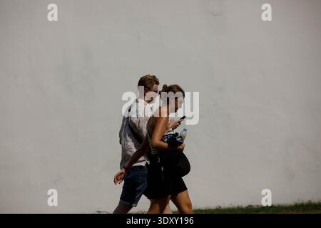 BANGKOK, THAILAND-Feb 15, 2026: Tourist couple walking and exploring, tourists experiencing urban life abroad, side profile Stock Photo