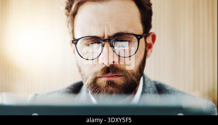 Laptop, reading and business man with glasses in office for finance review, planning and investment. Corporate, reflection and person on computer for Stock Photo
