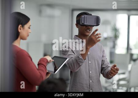 VR, glasses or people with tablet screen in office, testing or demo evaluation for engineering research. Prototype trial, tech or developer with Stock Photo