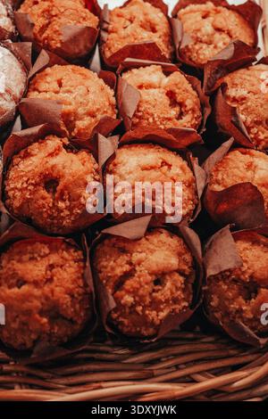 Delicious sweet cupcakes displayed on a bakery shop counter. Homemade desserts in a pastry store showcase, perfect for breakfast, celebrations, and sw Stock Photo