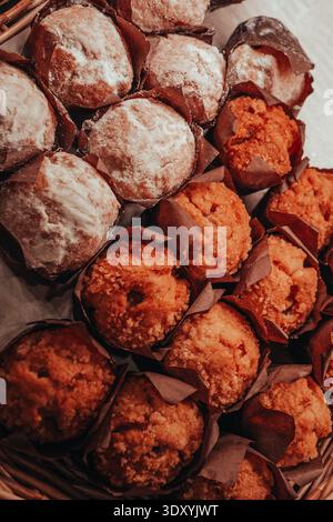 Delicious sweet cupcakes displayed on a bakery shop counter. Homemade desserts in a pastry store showcase, perfect for breakfast, celebrations, and sw Stock Photo