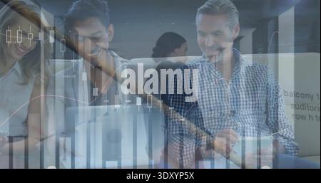 Analyzing financial graphics, team using laptop and tablet in modern lounge, man in checkered shirt Stock Photo