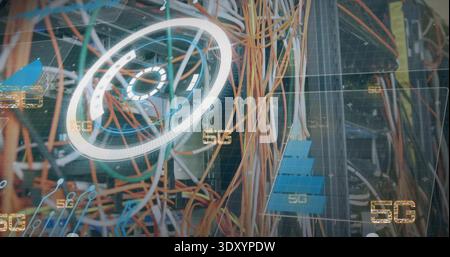 Showing orange yellow cables snaking through network rack, with blue patch modules and 5G overlays Stock Photo
