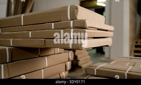 Close-up of stacked cardboard packages strapped and ready for shipping in a warehouse Stock Photo