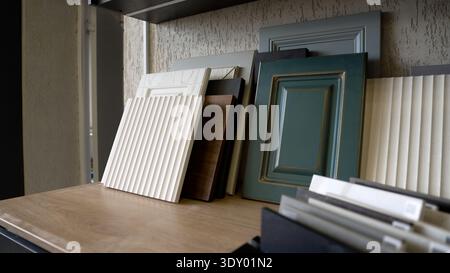 Variety of cabinet door material samples for interior design, showing different styles, colors, and textures. Stock Photo