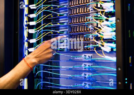 close up of server racks in a data center used for ai with cables and plugs. Concept of hardware and connectivity for AI computing center Stock Photo