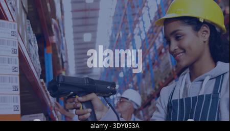 Scanning woman wearing yellow hardhat and striped-apron using scanner-gun in long aisle, copy space Stock Photo