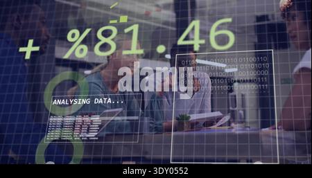 Reviewing team of four in business analyzing data in office with laptop, overlay ANALYSING DATA Stock Photo