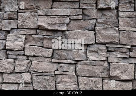 Natural stone wall texture. Rough rock masonry abstract background Stock Photo