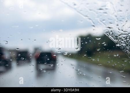 Rain drops on car windshield while driving on highway in rainy weather near Montreal Stock Photo