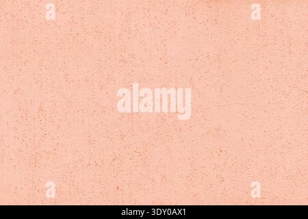 Pastel coral color old textured plaster background. Light orange rough aged exterior wall texture Stock Photo