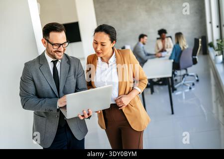Mixed team of software engineers brainstorming ideas. Diverse app developers collaborating as group Stock Photo
