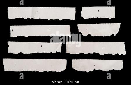 Pieces of ripped paper on black background Stock Photo
